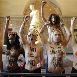 Femen activists demonstrate in the Louvre02